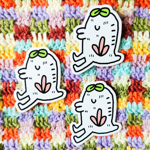 Tarra, joka esittää valkoinen olentoa. Sillä on päässään kaksi lehteä. Olento muistuttaa jonkinlaista kasvia, vaikka sillä onkin kaksi jalkaa. Olennolla on mahtavat pusuhuulet.