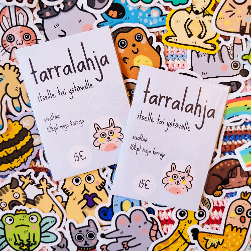 Kuvassa on kaksi vaaleansinistä tarrapakettia värikkäiden eläintarrojen päällä.